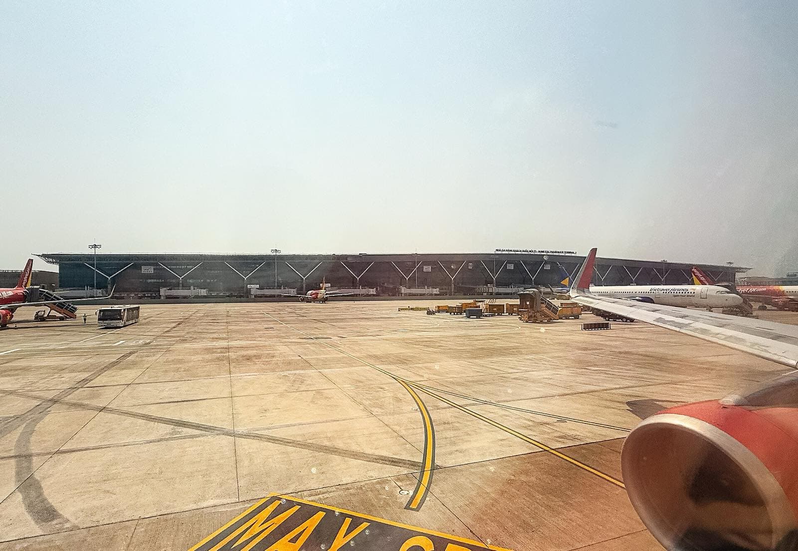 Tan Son Nhat Terminal 3 from the apron, with Vietjet and Vietravel Airlines aircraft
