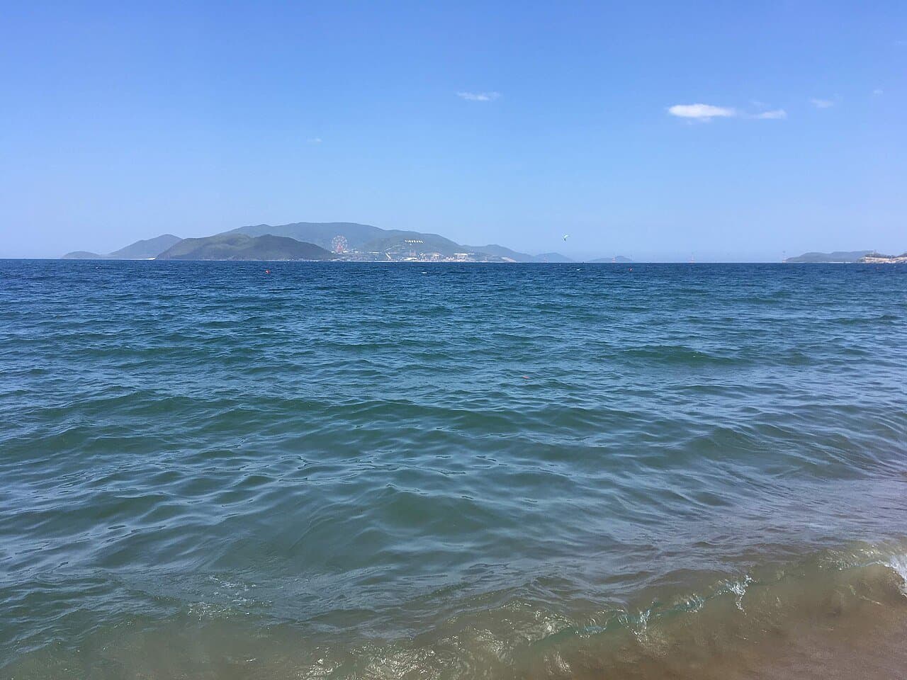 Hon Tre island in Nha Trang bay seen from the city beach