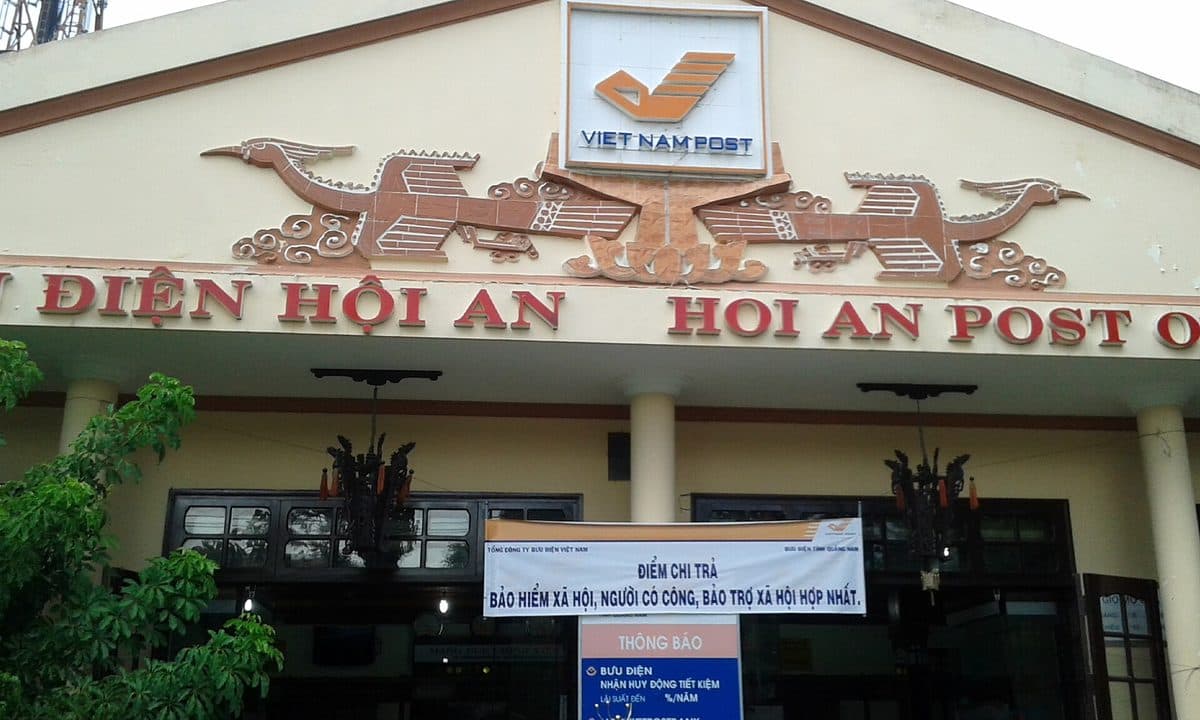 Front of Hoi An post office with the Vietnam Post logo and the sign Bưu điện Hội An