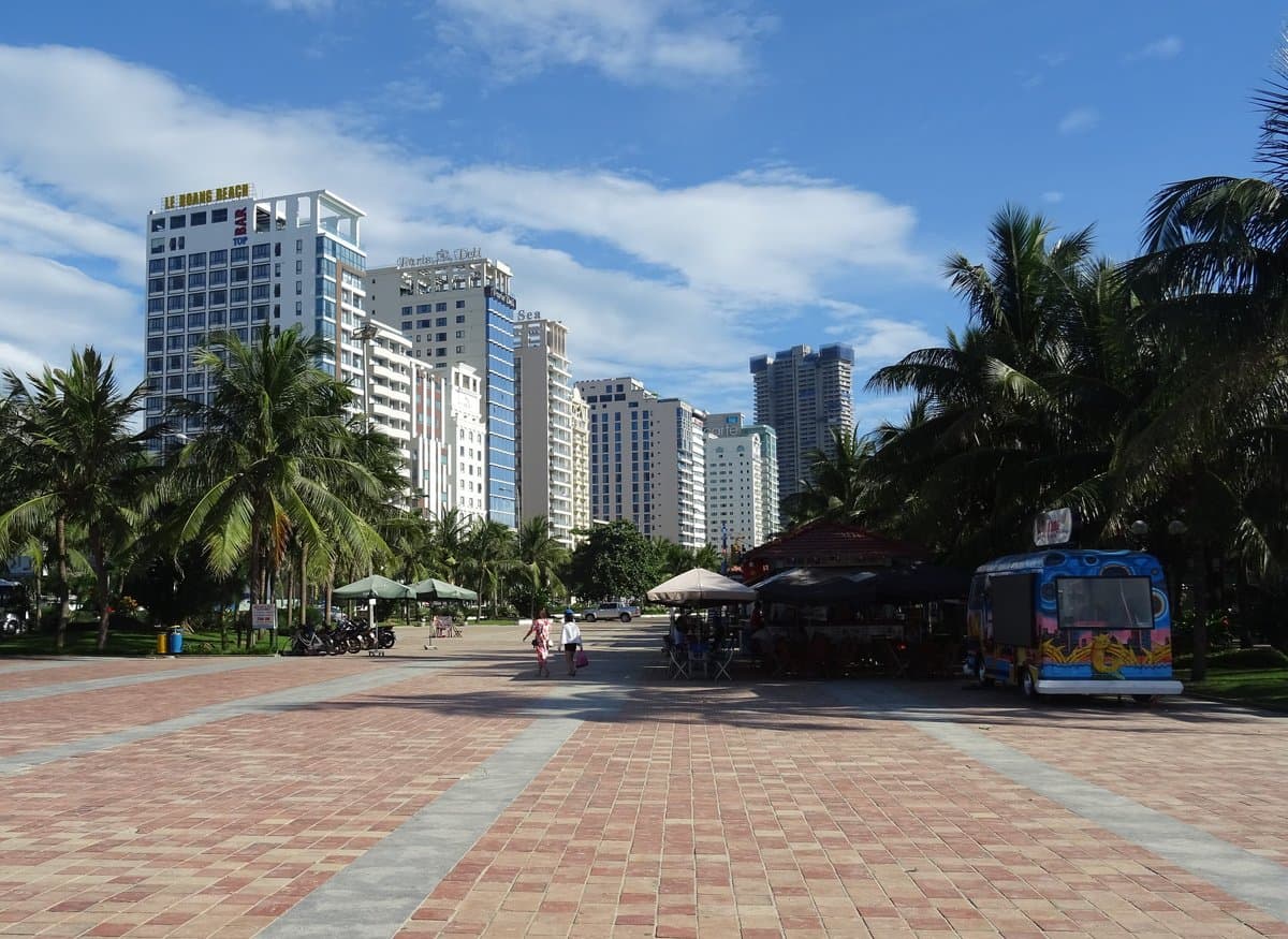 Line of resort high-rises along the My Khe beachfront promenade in Da Nang among palm trees