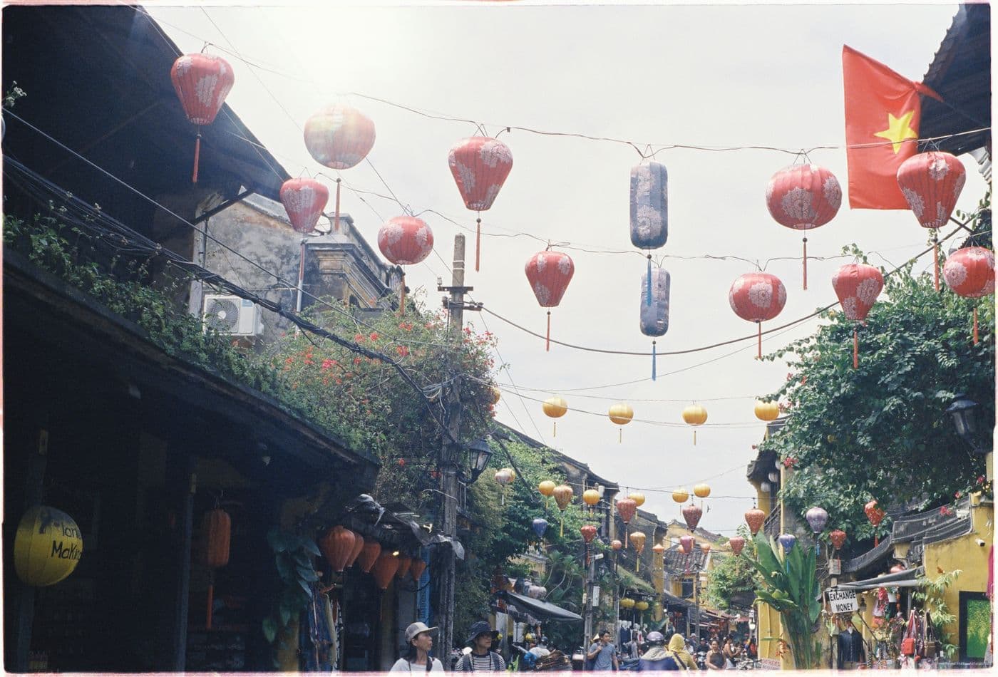 Hoi An Old Town street with lanterns and a Vietnamese flag