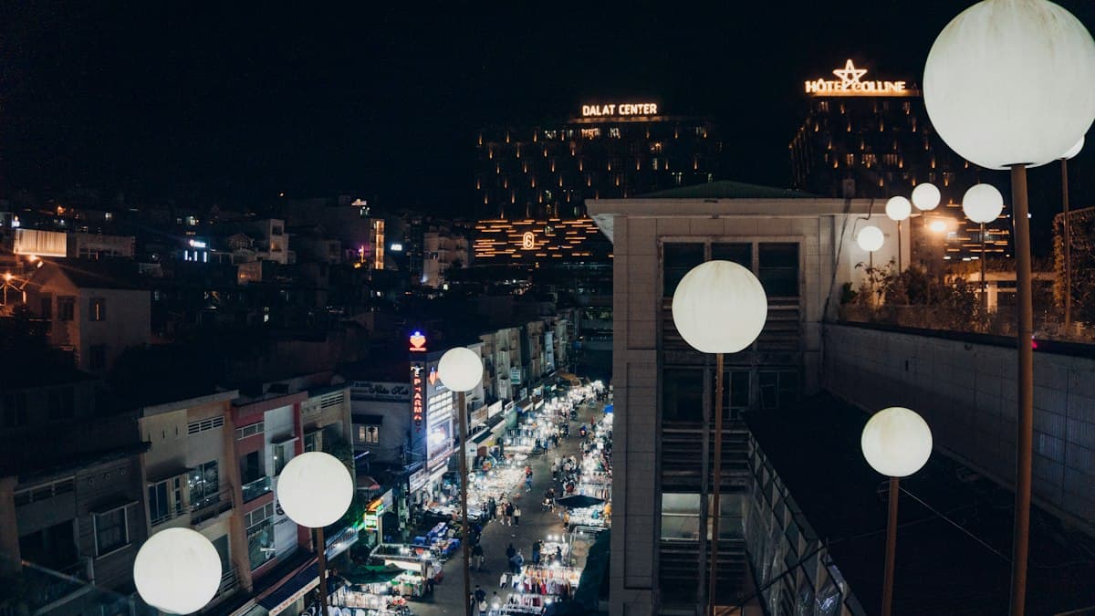 Da Lat at night from above with lit buildings and night market stalls below