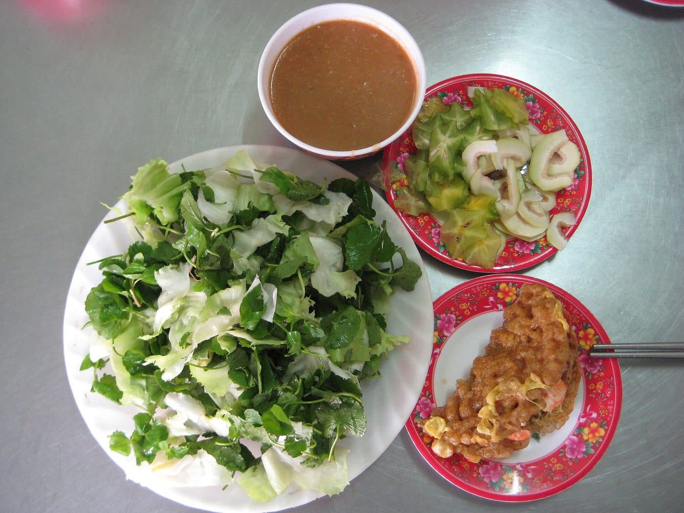 Хрустящий блинчик bánh khoái с креветкой, миска соуса, зелень и карамбола