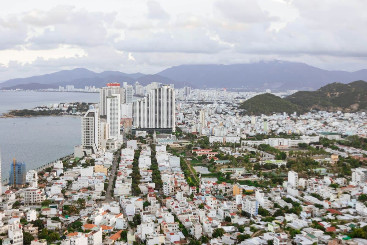 Nha Trang from above: high-rises by the bay, low-rise blocks and mountains behind the city