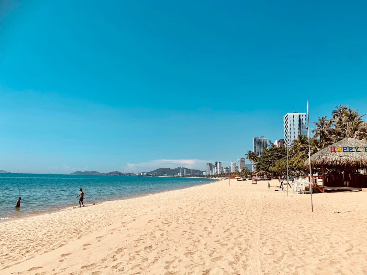Nha Trang city beach: pale sand, palms and high-rises along the seafront