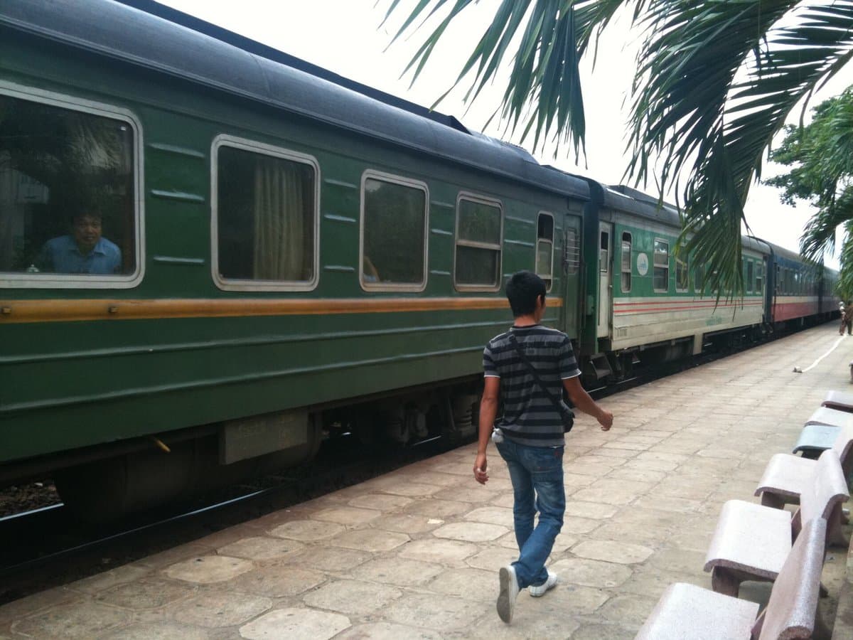 Green carriage of a passenger train at the Thap Cham station platform in Phan Rang