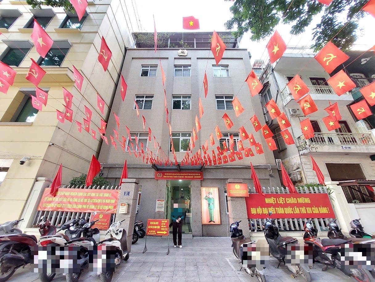 Hoan Kiem ward police station in Hanoi decorated with flags, motorbikes at the entrance