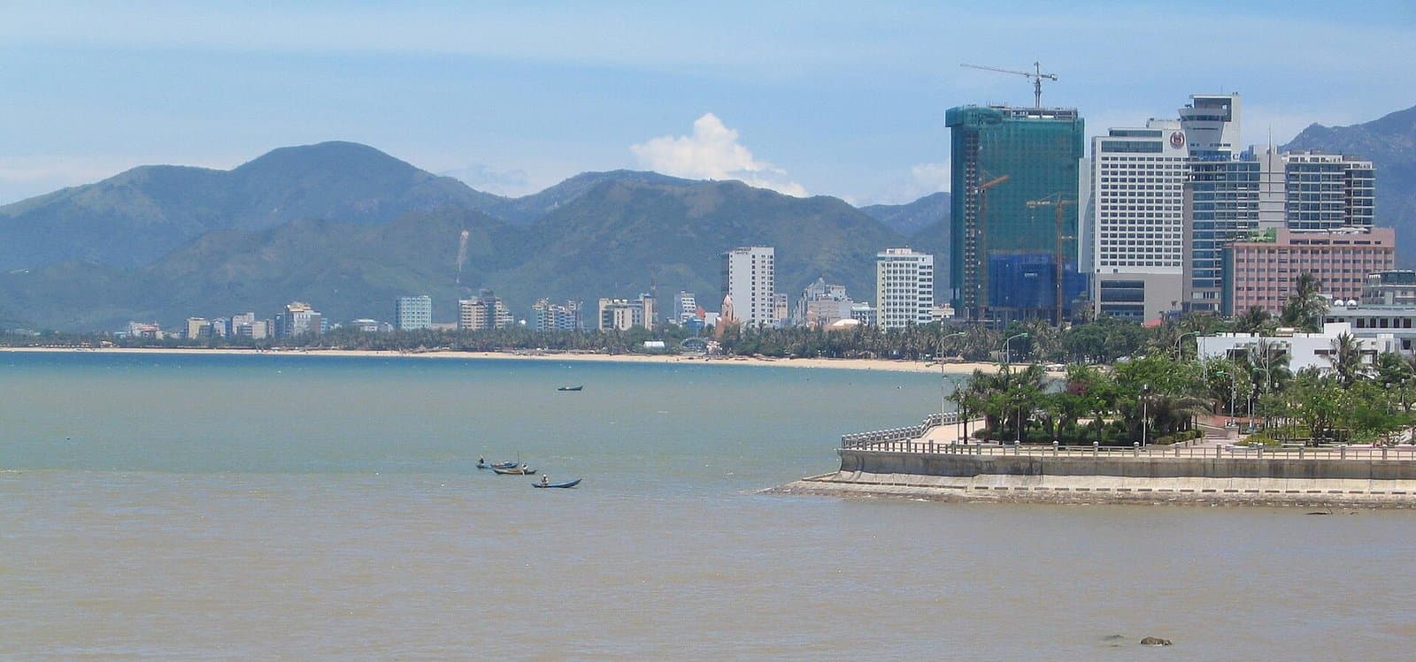 High rises along the Nha Trang coastline with mountains behind the bay