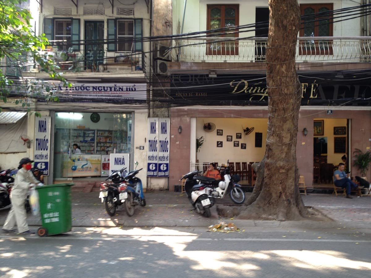 Pharmacy signage and street signs written only in Vietnamese in Hanoi