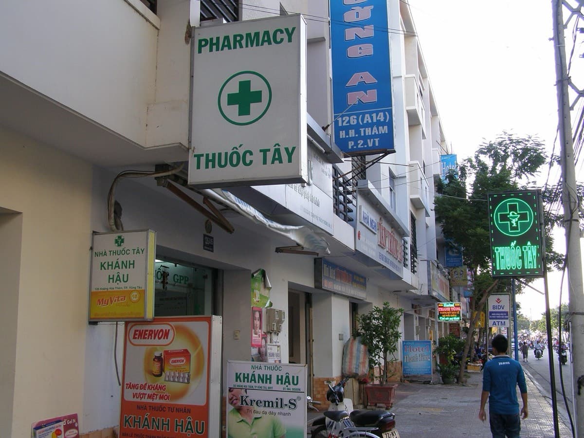 A Vietnamese pharmacy with a green cross and a nha thuoc sign in Vung Tau