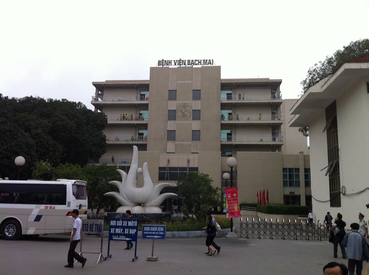 A large public hospital building in Hanoi with a sign for the outpatient department